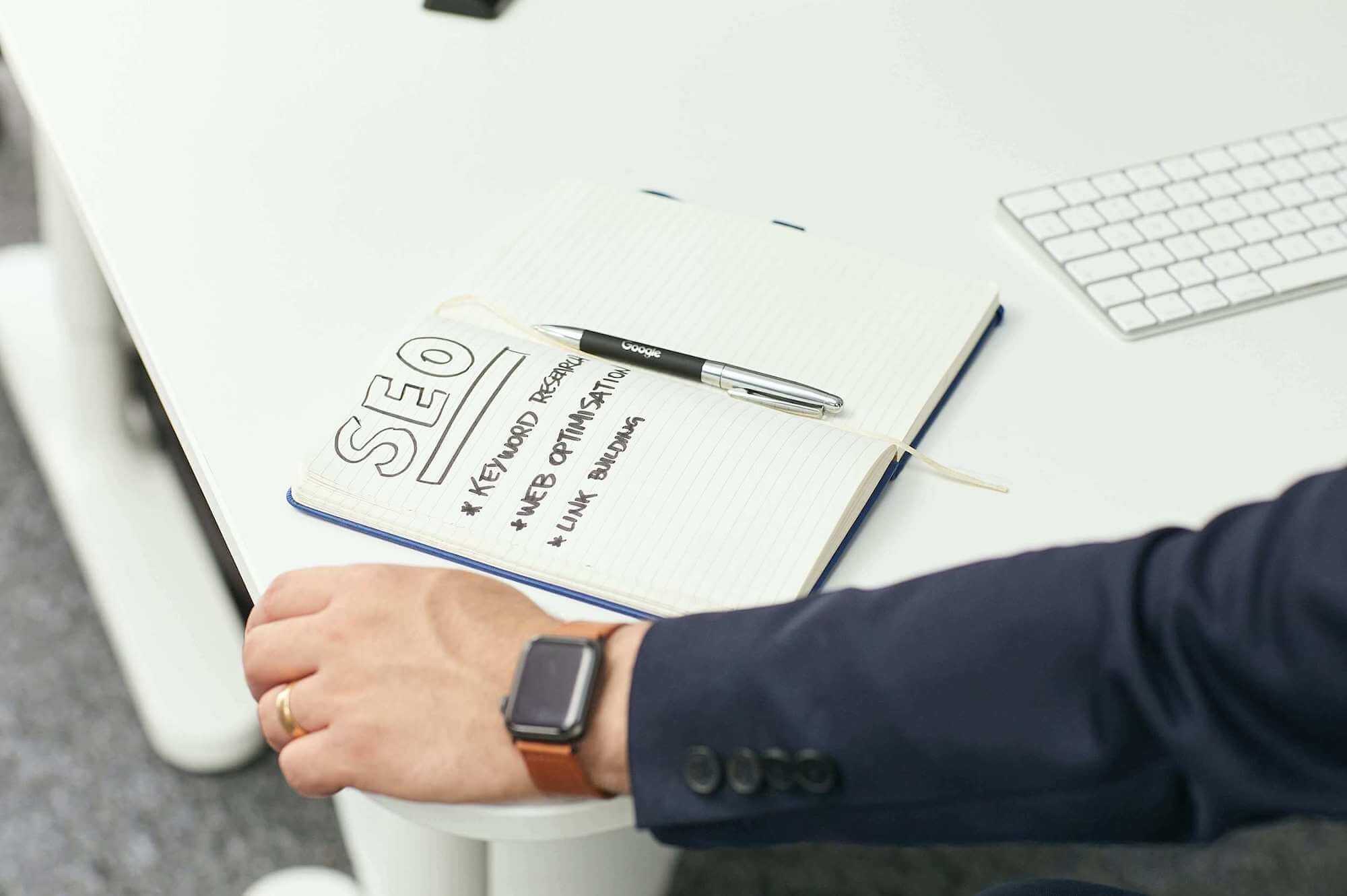 Man's hand with paper on a desk
